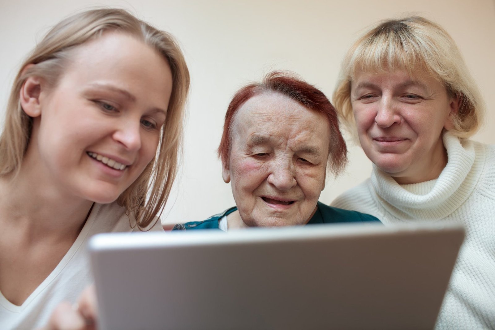 Tech Support Midcoast Maine. Three women of different ages look at a tablet together.